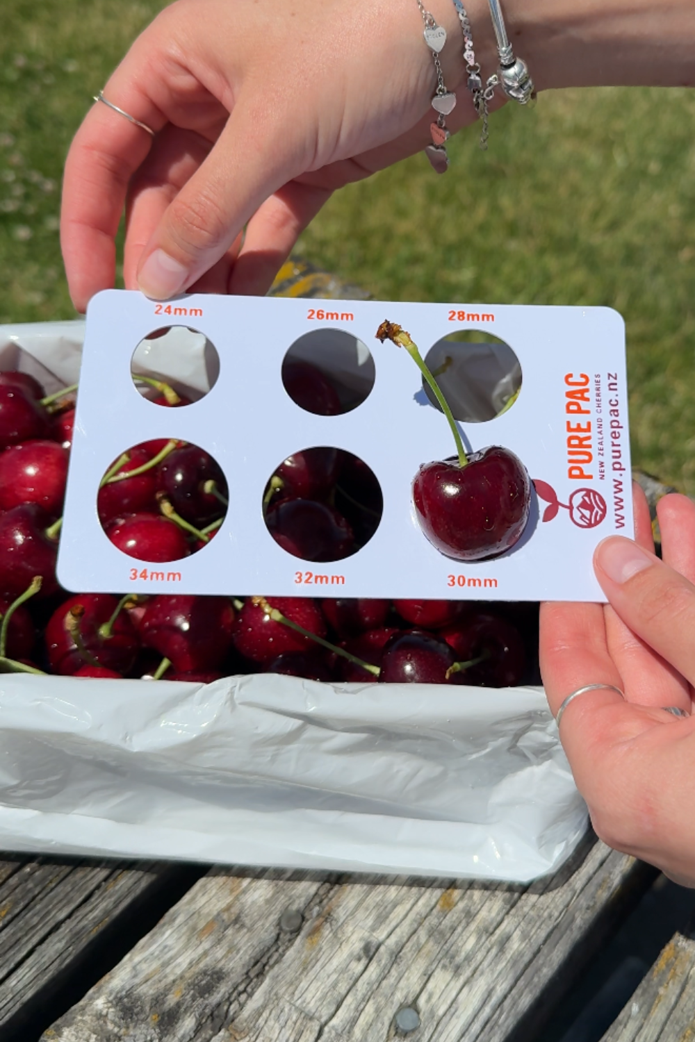 A 1kg box of red Pure Otago Direct cherries being opened